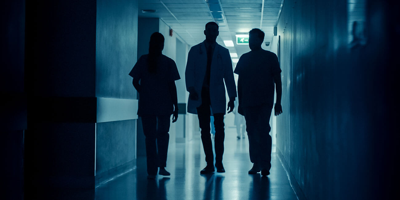 Doctors walking facility with power outage